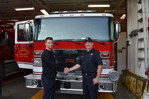 men shaking hands in front of truck