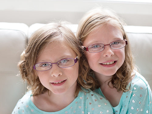 Two young girls in hospital gowns
