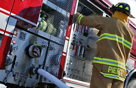 Firefighter beside truck