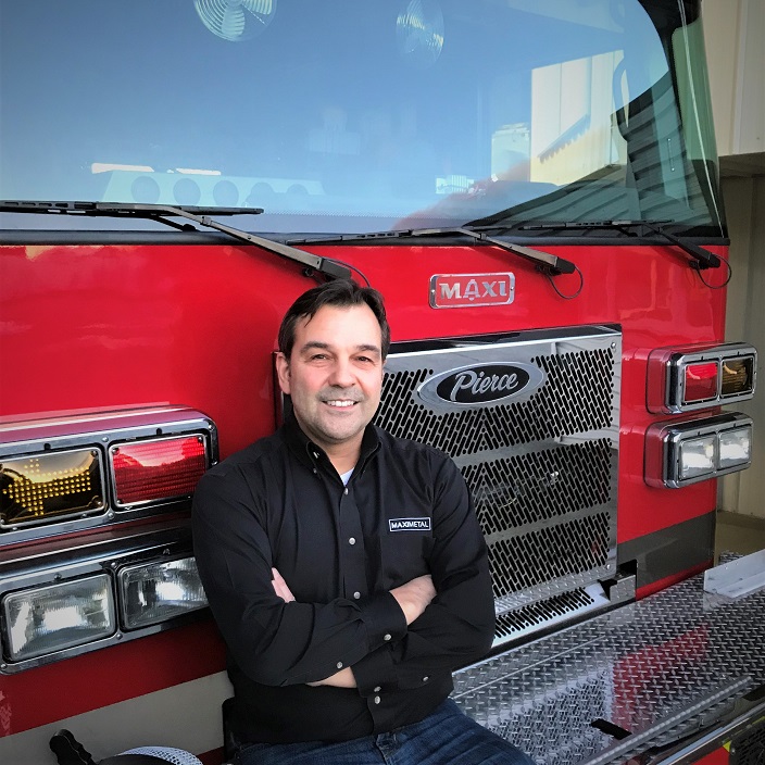man sitting on bumper of fire truck